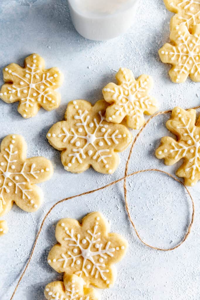 Snowflake sugar cookies, brown twine and a jug of milk.