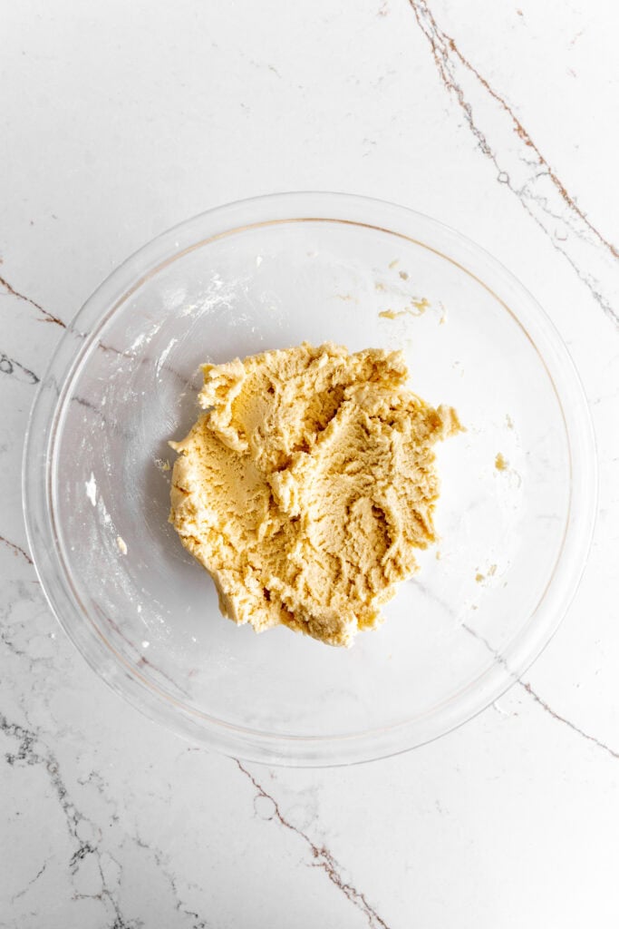 Sugar cookie dough in a glass bowl.