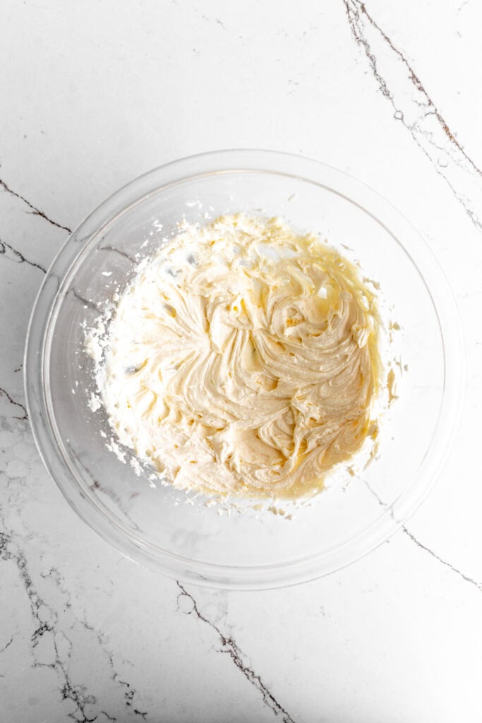 Creamed butter and sugar in a glass bowl.