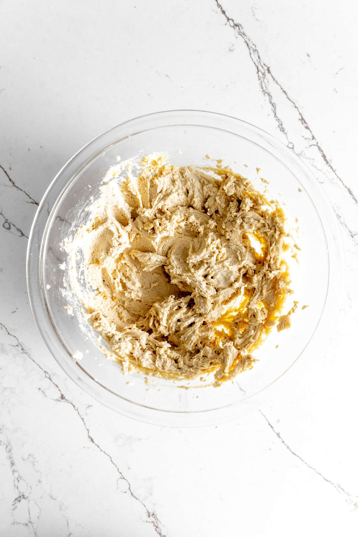 Glass bowl of creamed butter and sugar.