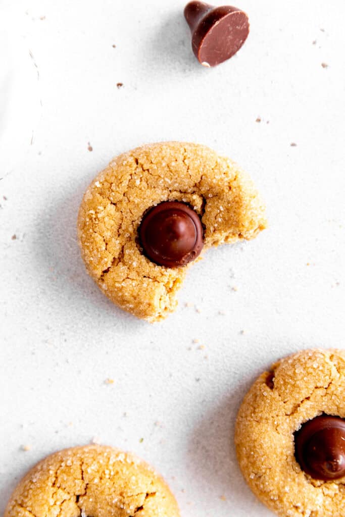 Peanut butter blossom cookie with a bite taken out of it.