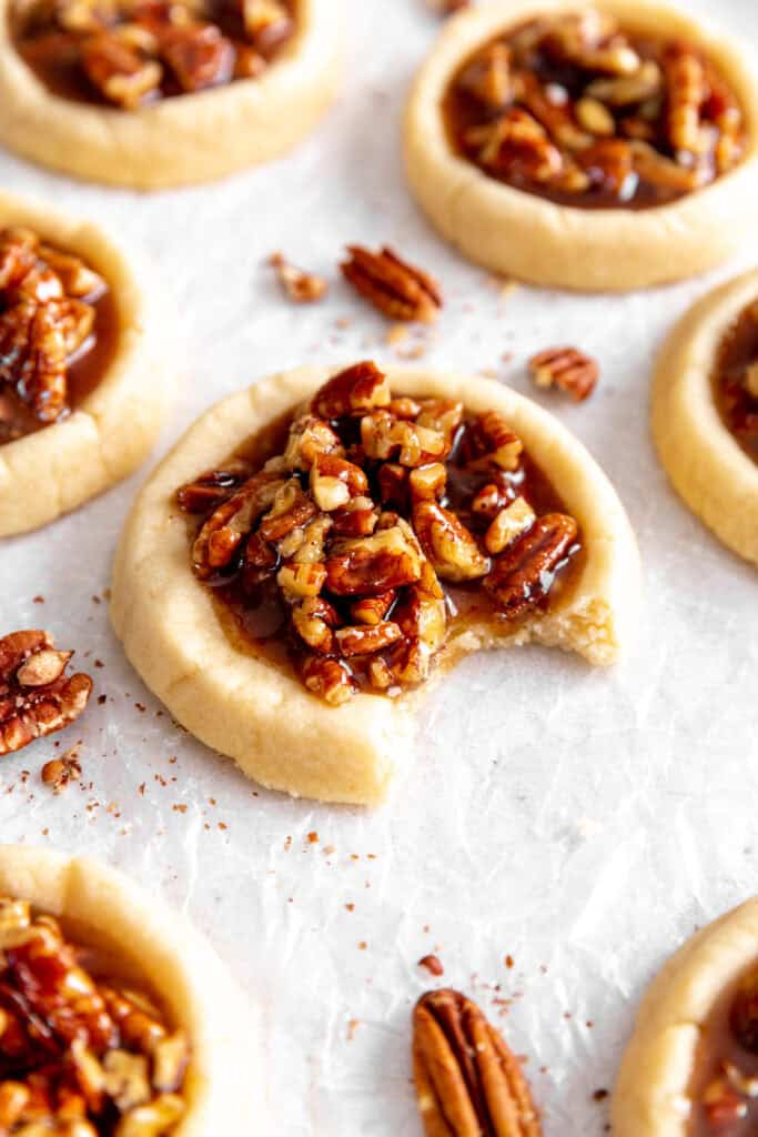 Vegan pecan pie cookie with a bite taken out of it.