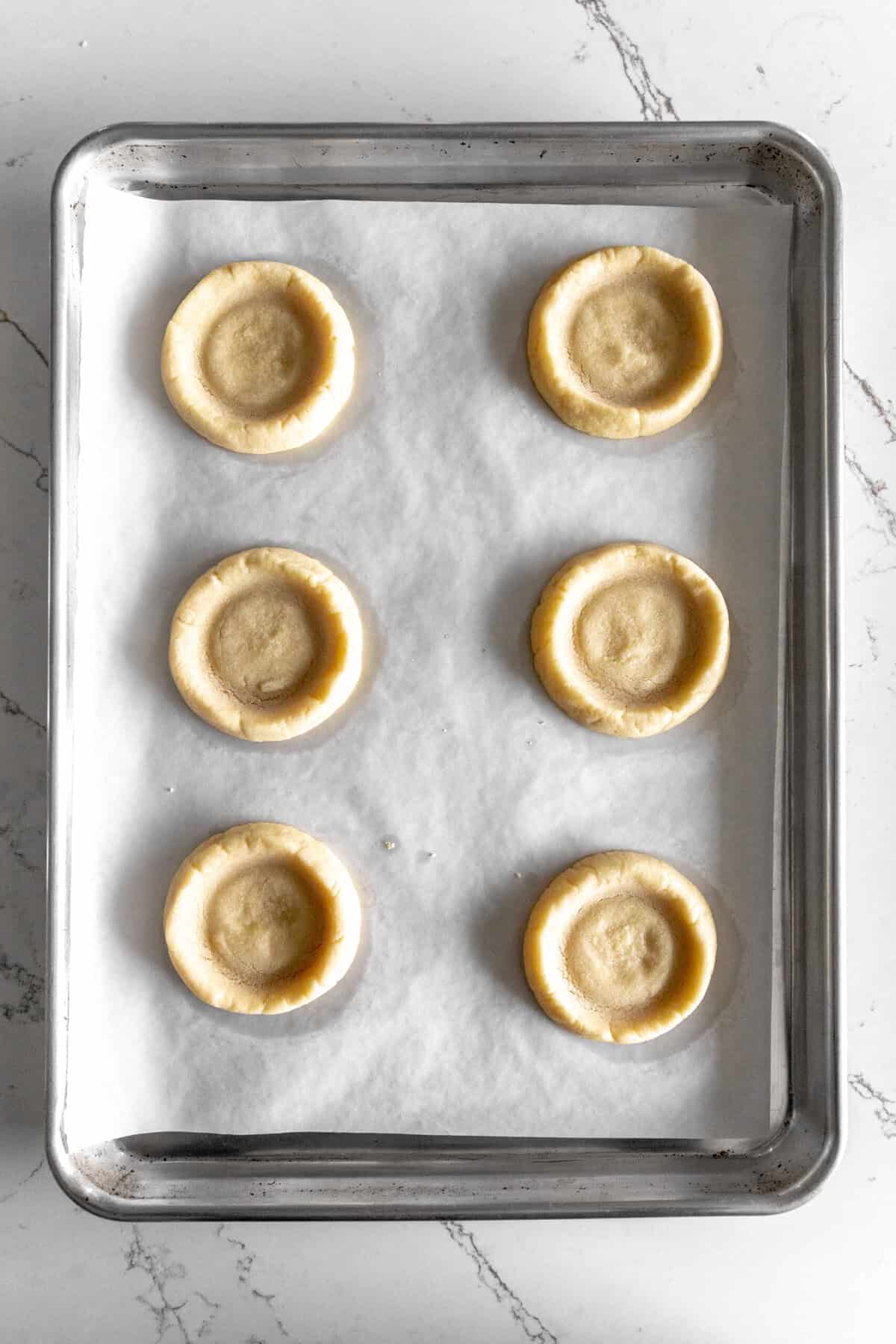 Baked pecan pie cookies on a baking sheet.