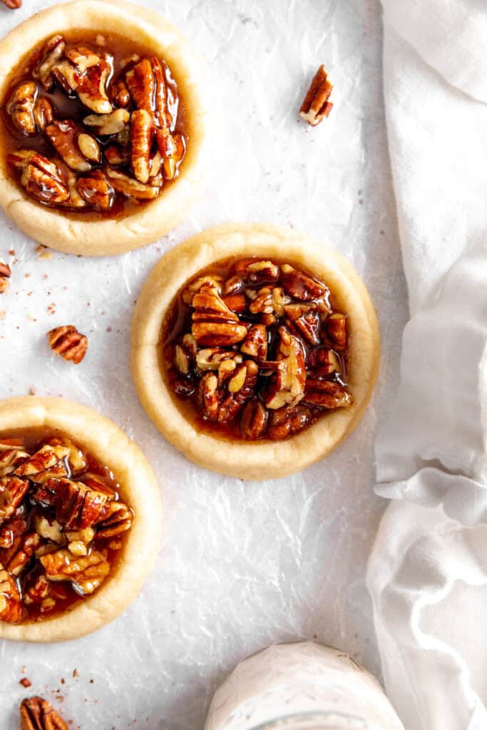 Vegan pecan pie cookies and a white linen napkin.