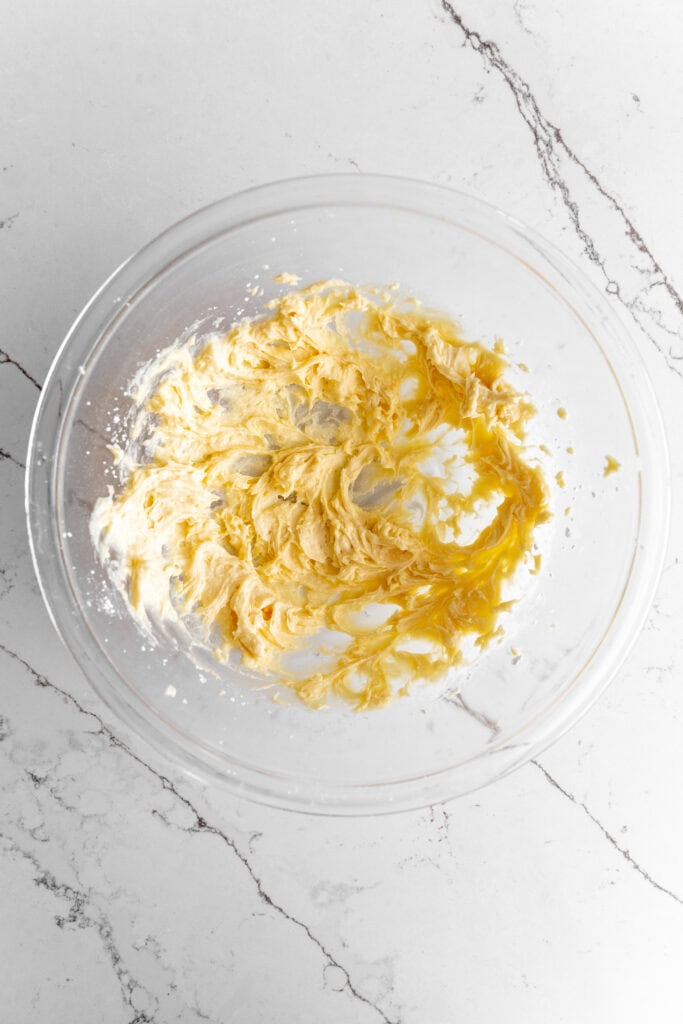 Creamed butter and sugar in a glass mixing bowl.