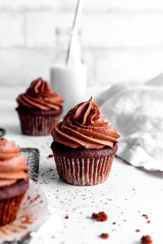 Chocolate cupcake, a jug of milk and a linen napkin.