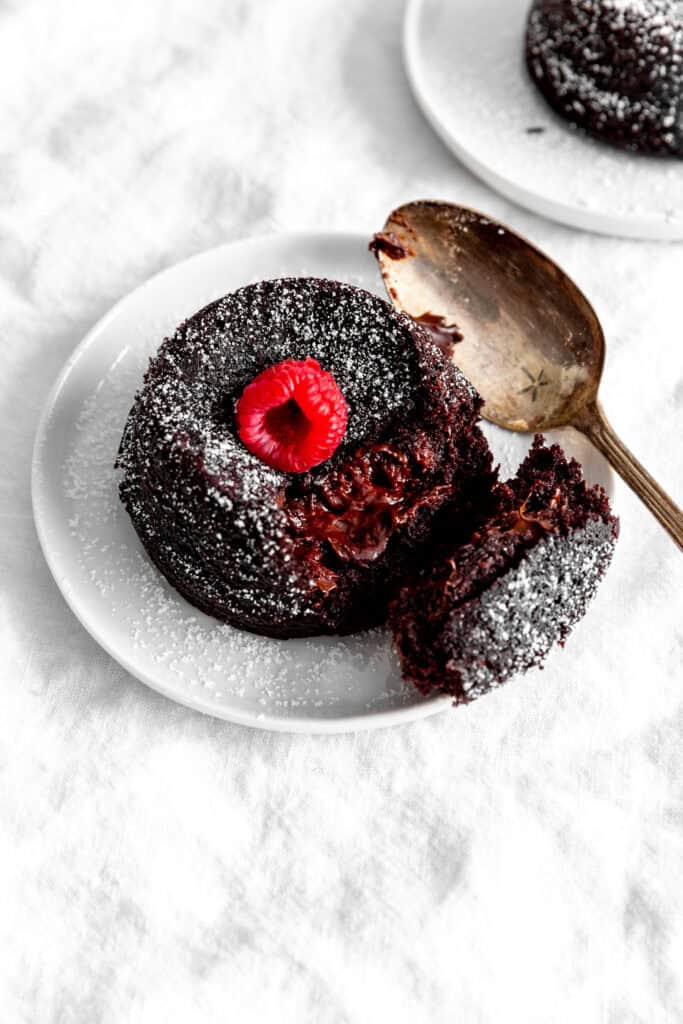 Spoon cutting into a chocolate lava cake.