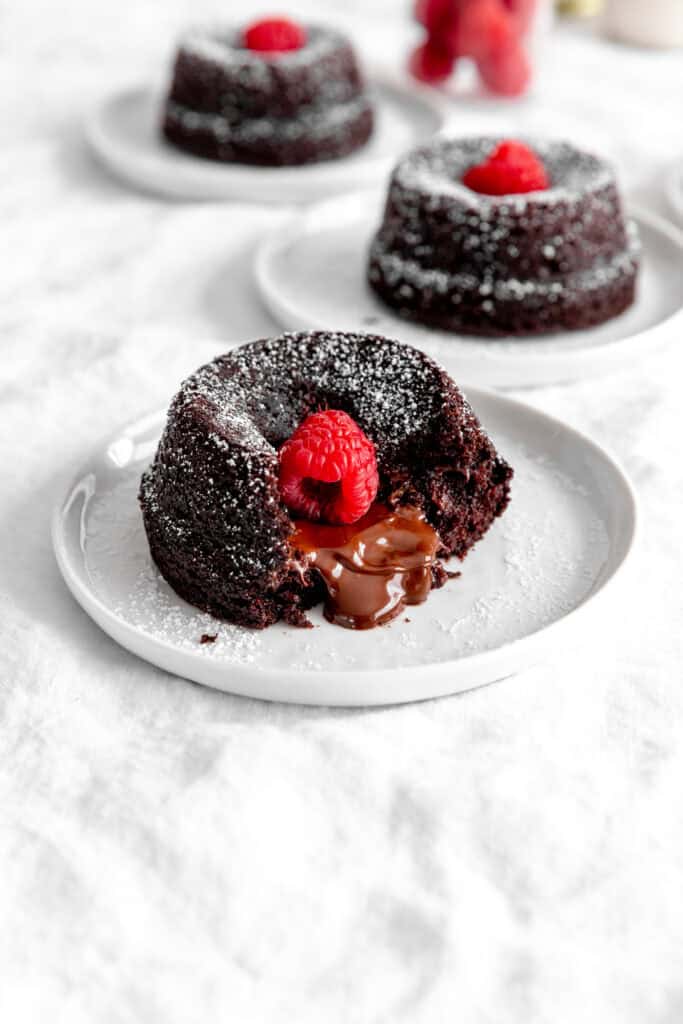 Lava cake topped with a raspberry oozing chocolate.