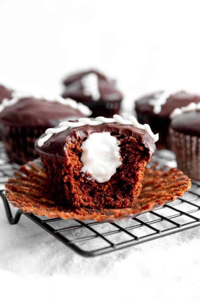 Hostess cupcake filled with vanilla creme with a bite taken out of it.