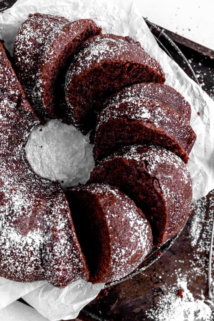 Sliced Kahlúa cake on a circular cooking rack on a baking sheet.