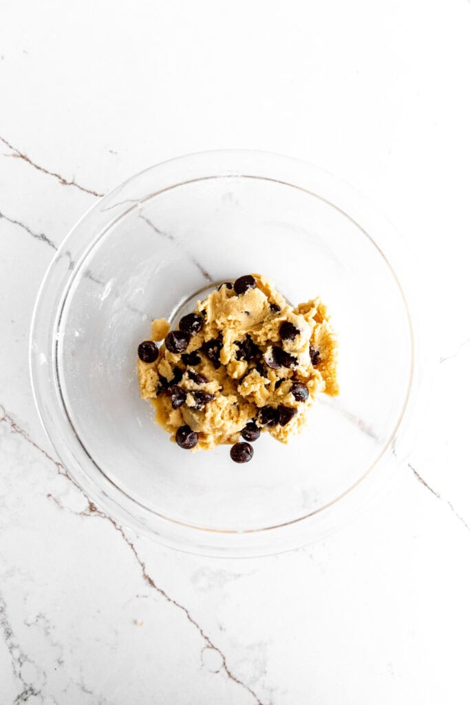 Glass bowl filled with chocolate chip cookie dough.