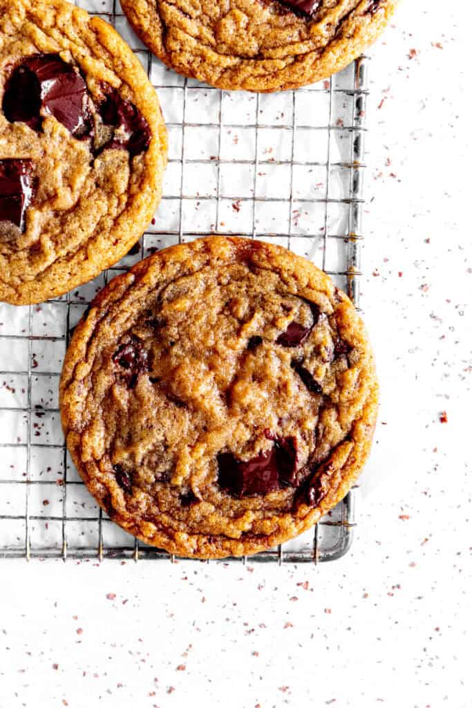 Toffee chocolate chip cookie on a wire rack.