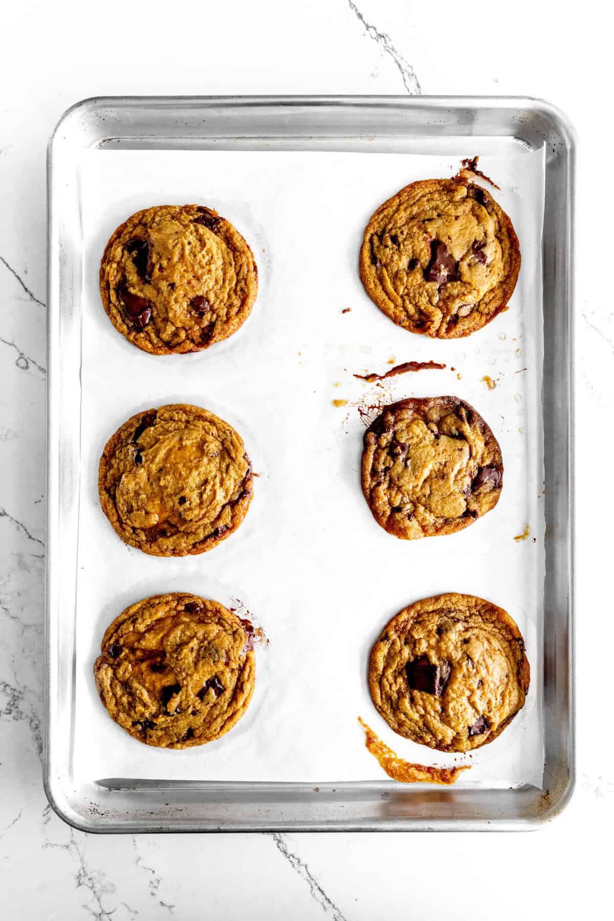 Baked toffee chocolate chip cookies on a baking sheet.