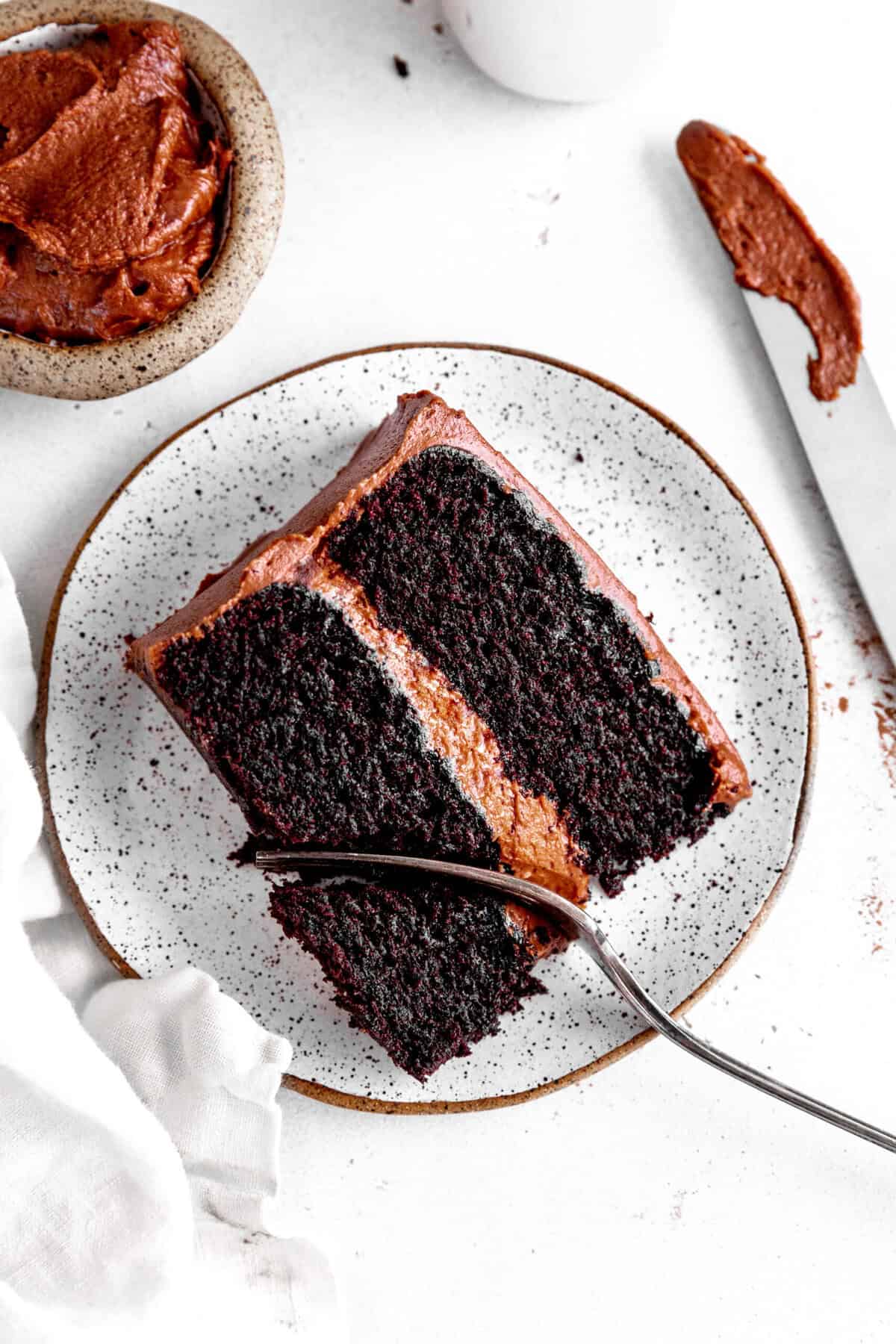 Fork cutting into a slice of chocolate cake.