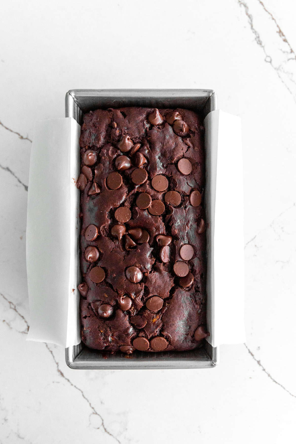 Baked chocolate zucchini bread in a loaf pan.