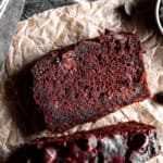 Slice of chocolate zucchini bread on a sheet of parchment paper.