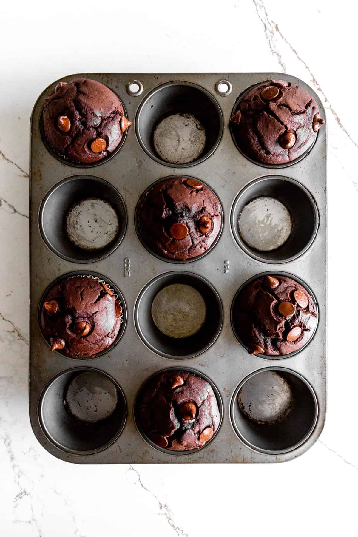 Baked chocolate muffins in a cupcake pan.