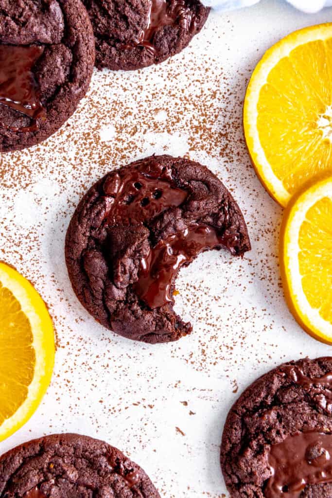 Orange chocolate cookie with a bite taken out of it.