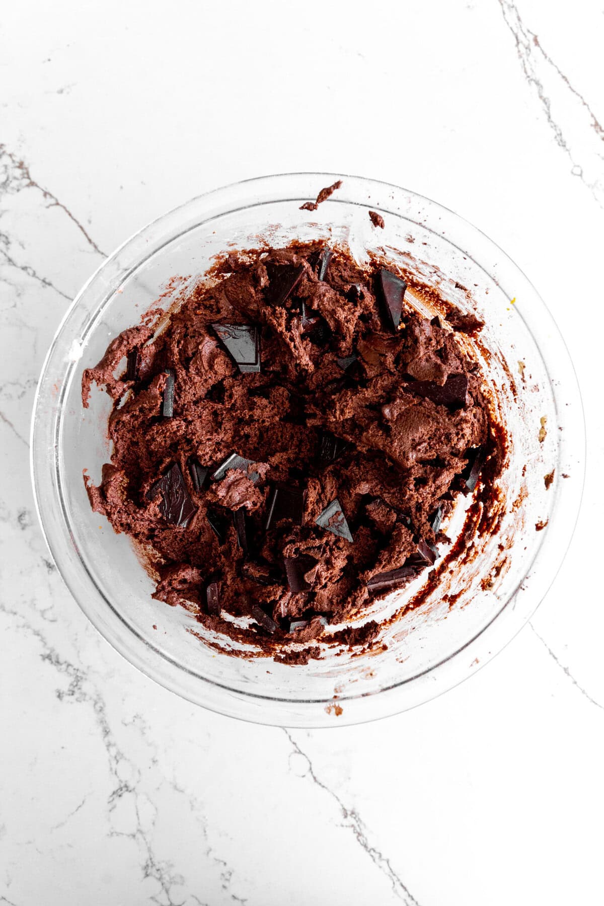 Orange chocolate cookie dough in a glass bowl.