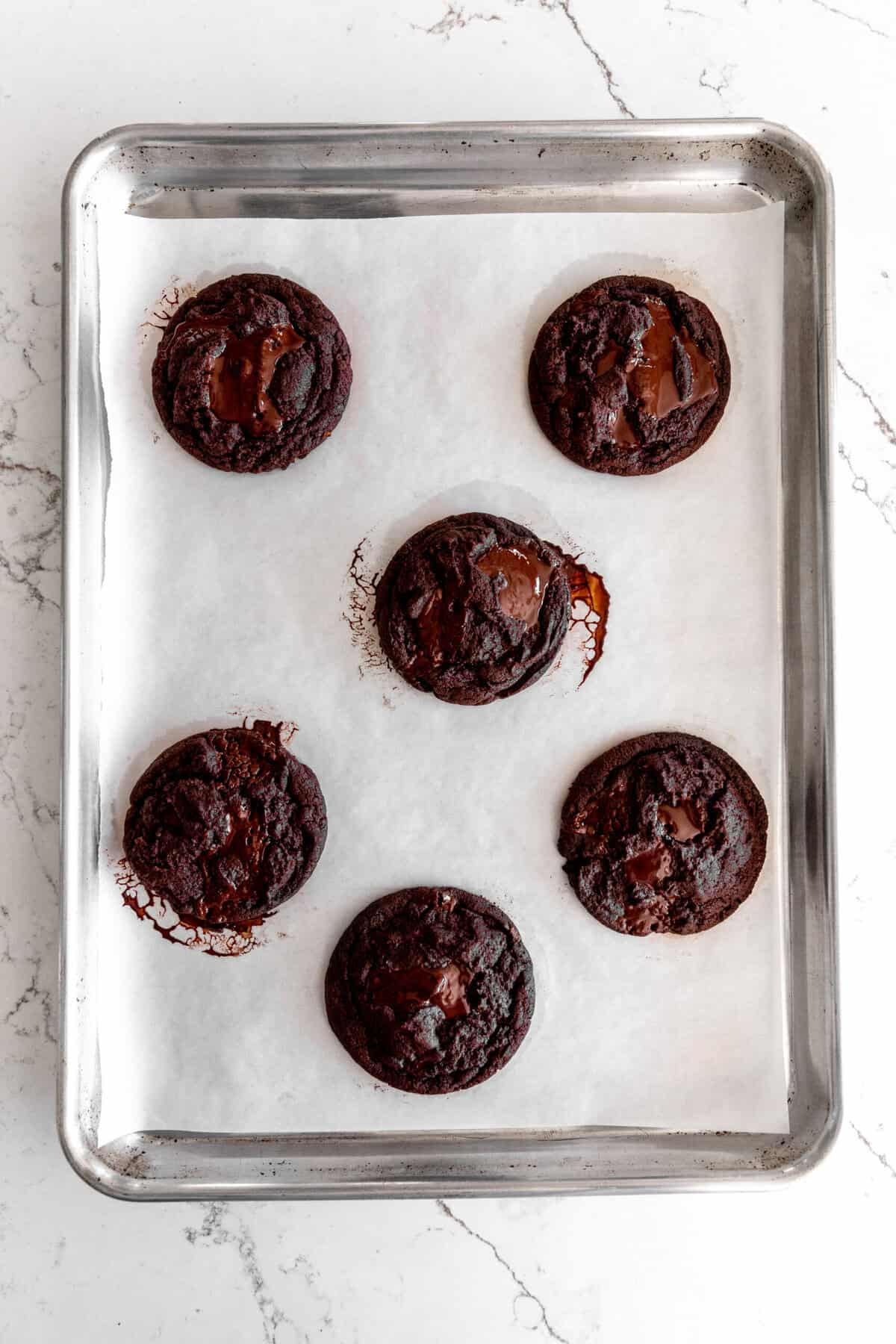 Baked orange chocolate cookies on a baking sheet.