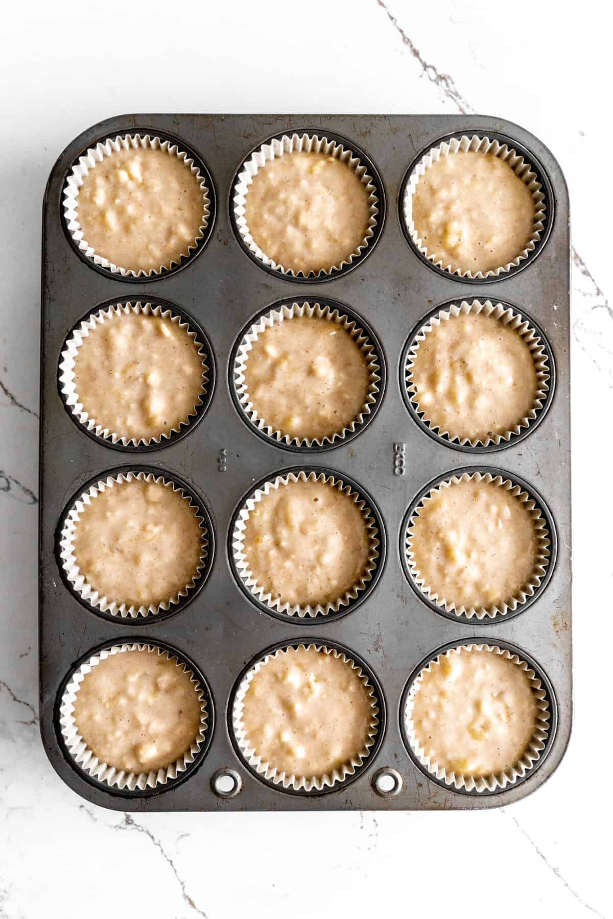 Unbaked banana cupcakes in a cupcake pan.