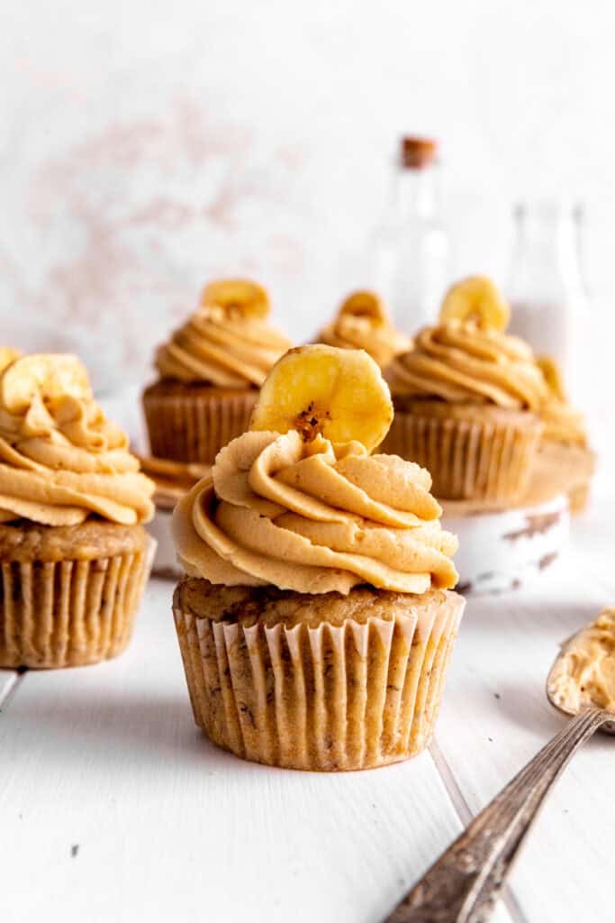 Peanut butter banana cupcake topped with a banana chip.