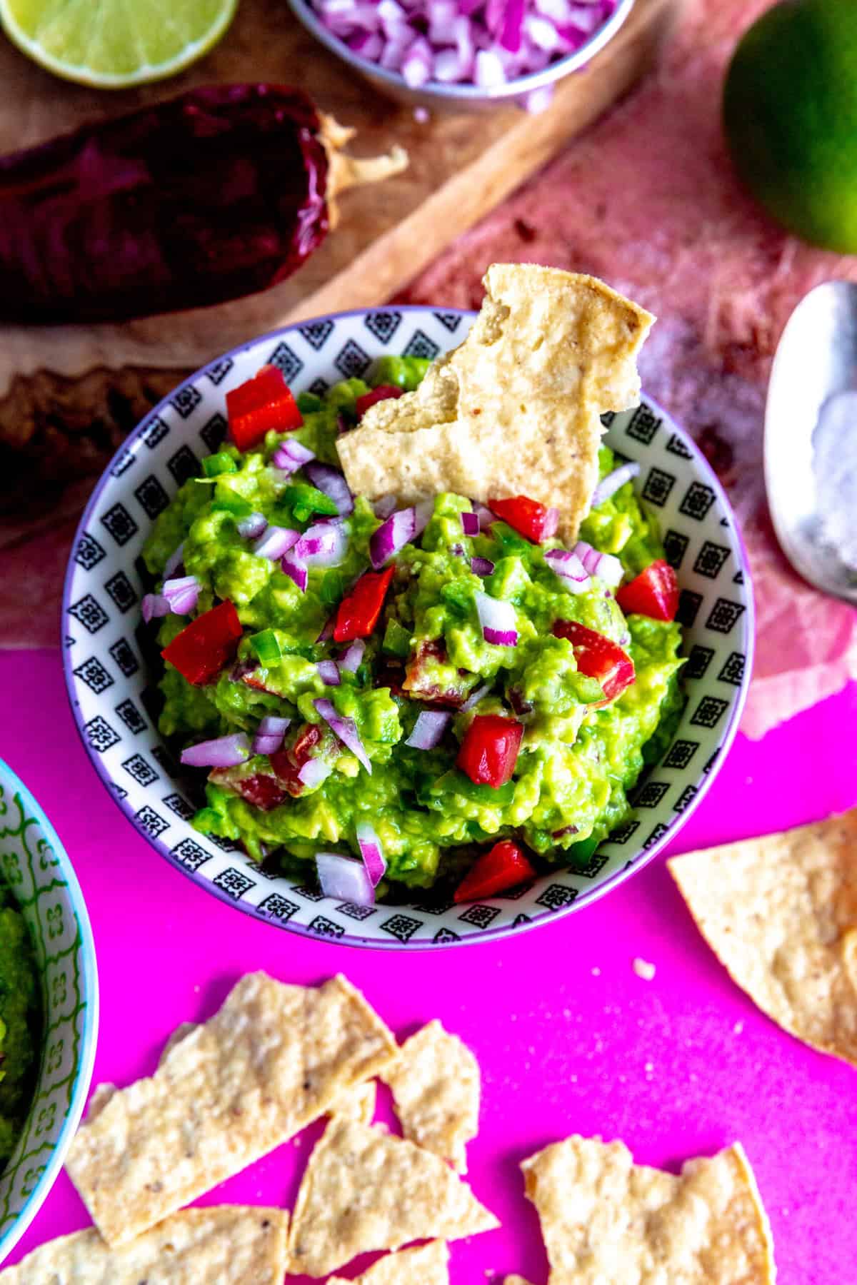 Chip dipping into a bowl of guacamole.