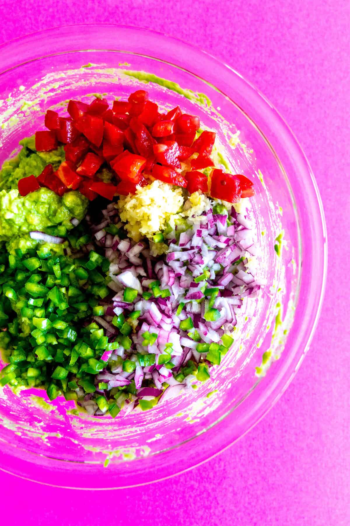 guacamole ingredients in a large glass bowl.