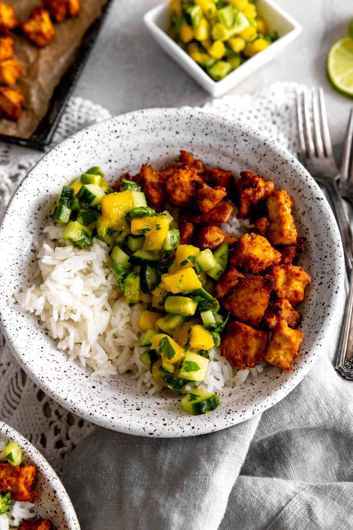 Bowl of mango and cucumber salsa and spiced tofu.