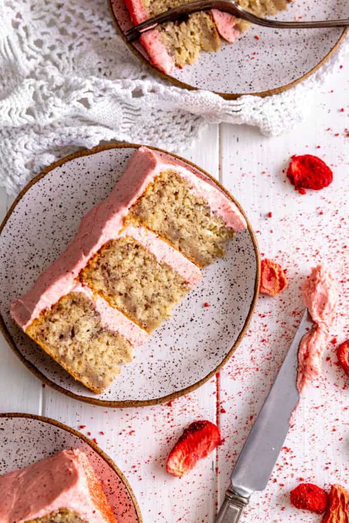 A slice of cake on a plate with strawberries