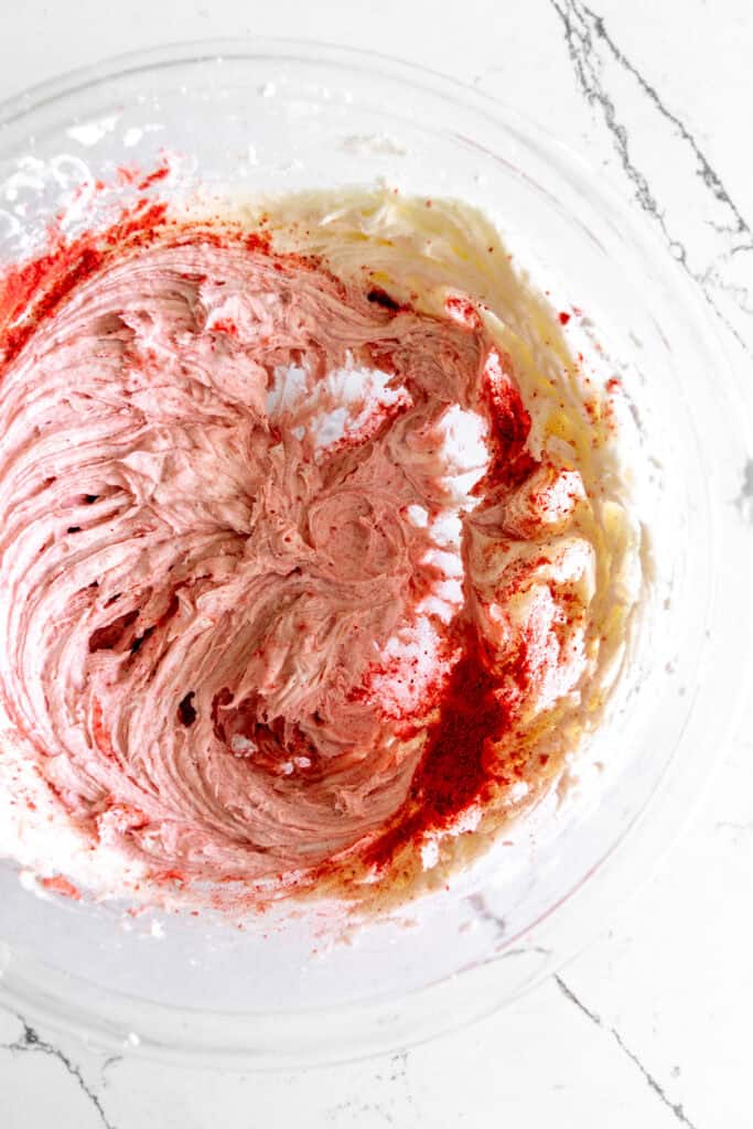A bowl of strawberry frosting.