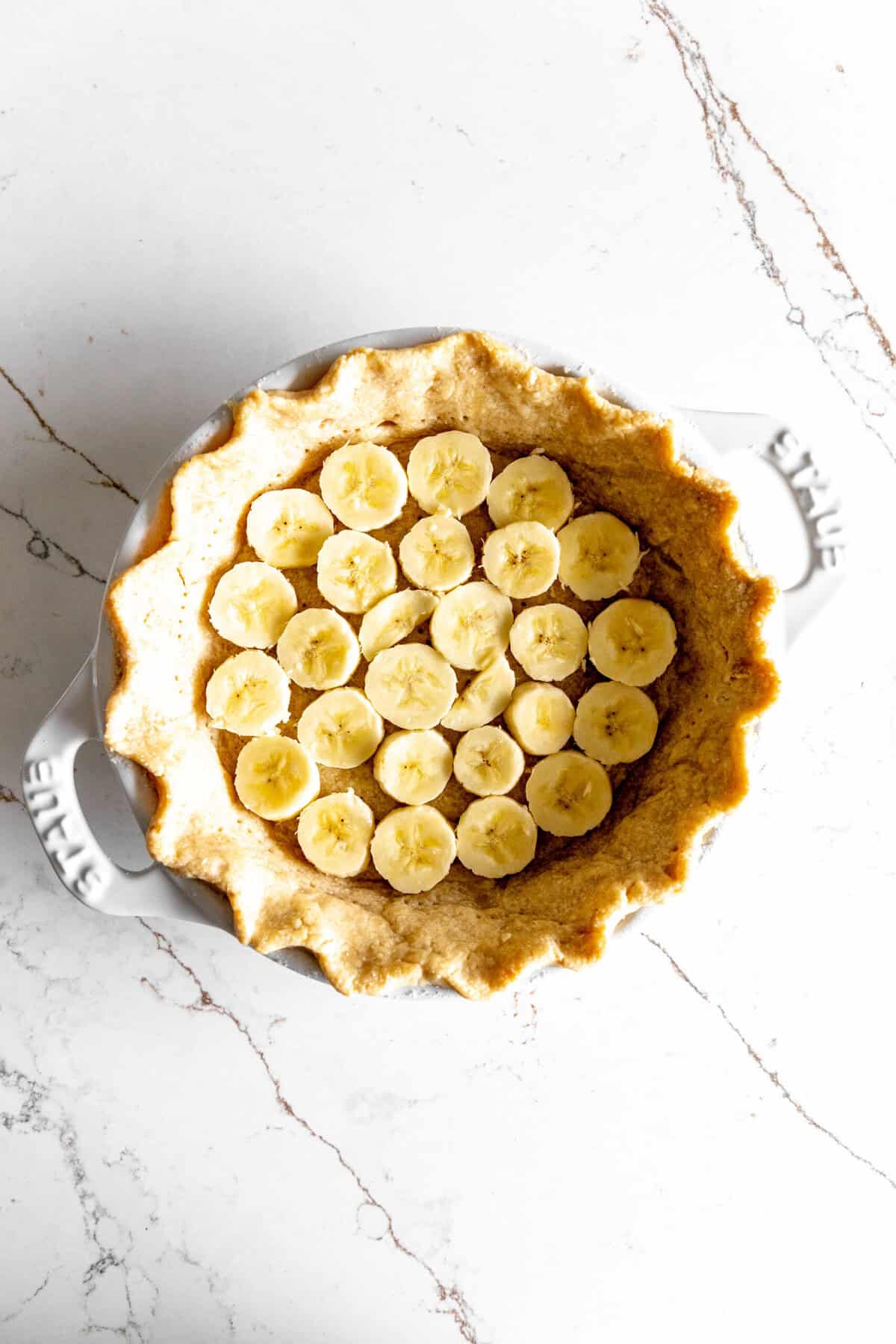Piecrust lined with banana slices.