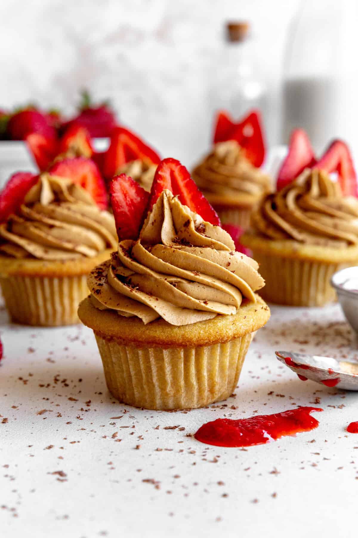 Strawberry tiramisu cupcakes and spilled strawberry jam.