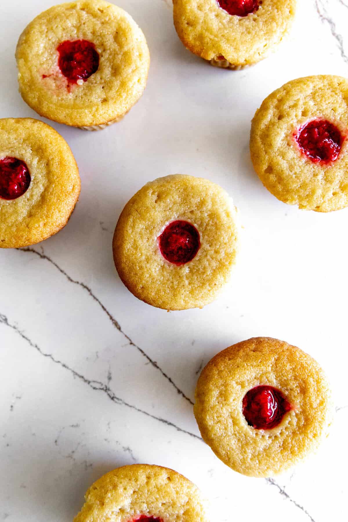 Vanilla cupcakes filled with strawberry jam.
