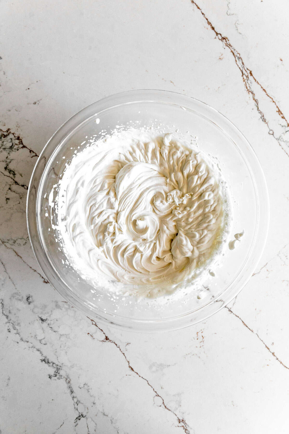 Whipped cream in a glass bowl.