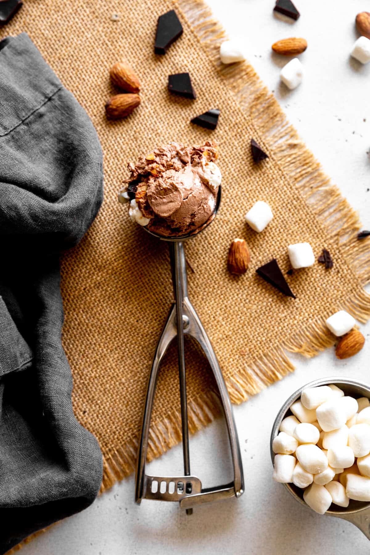 Ice cream scoop filled with rocky road ice cream.