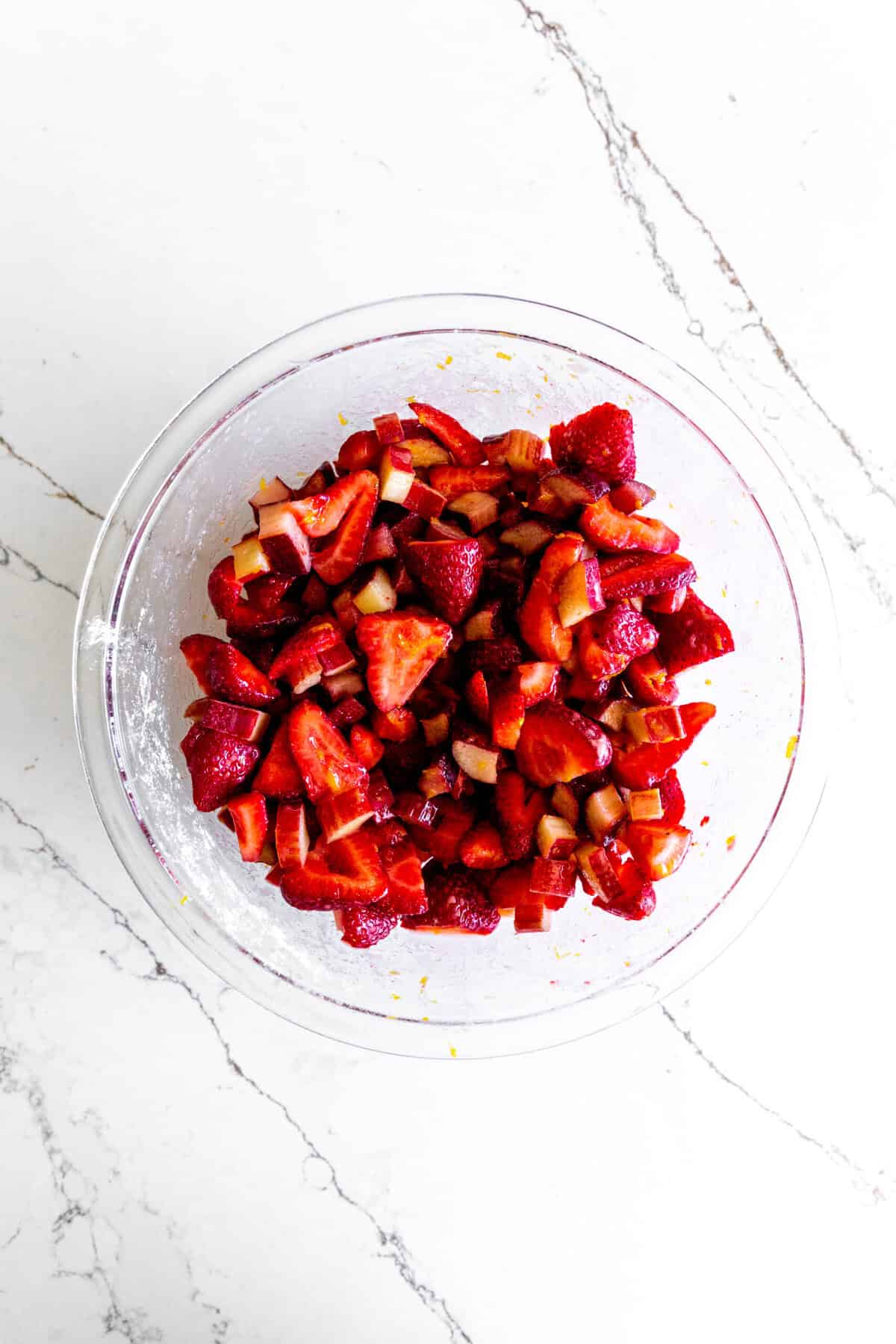 Strawberry rhubarb pie filling in a glass bowl.