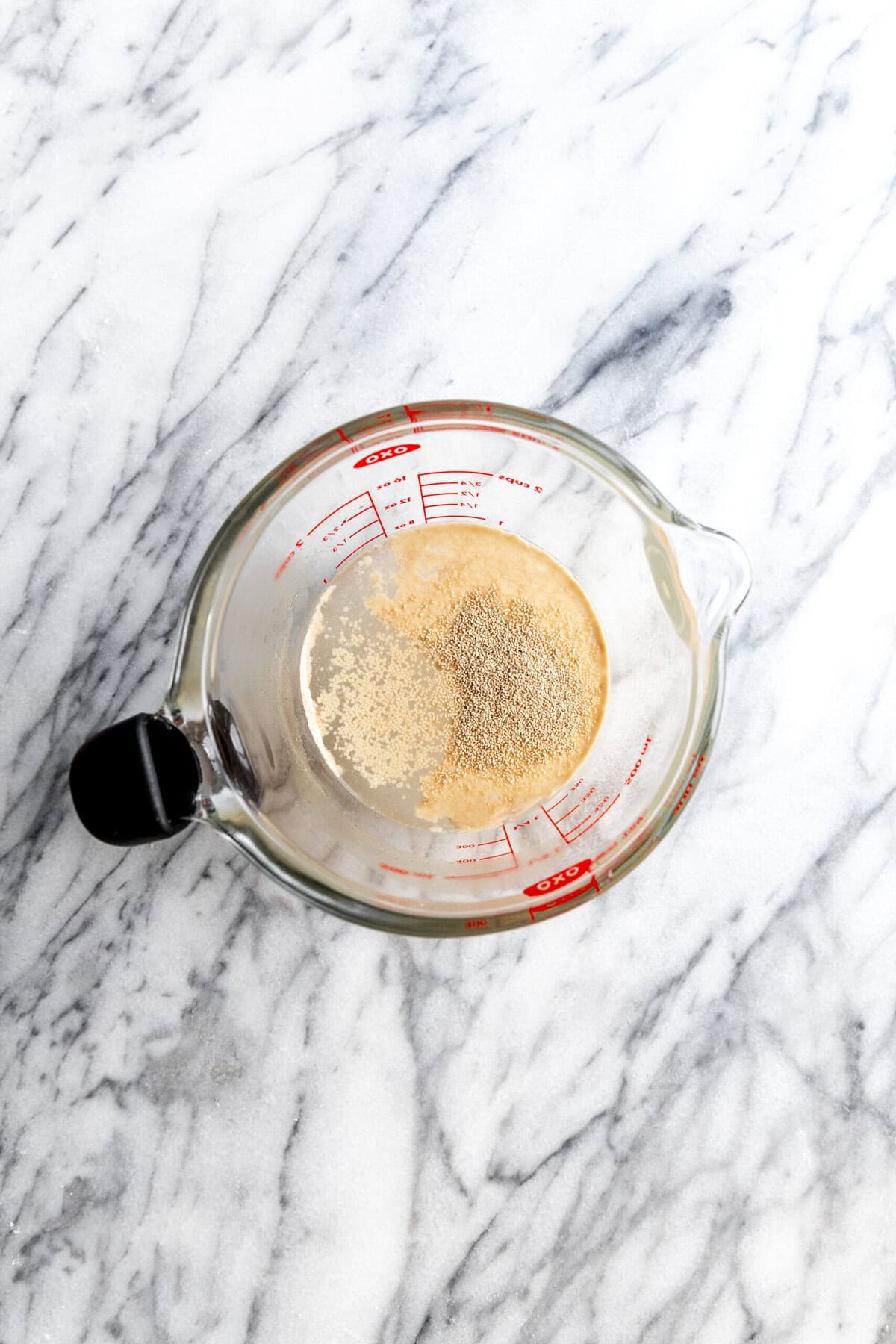 Yeast in a measuring cup of water.