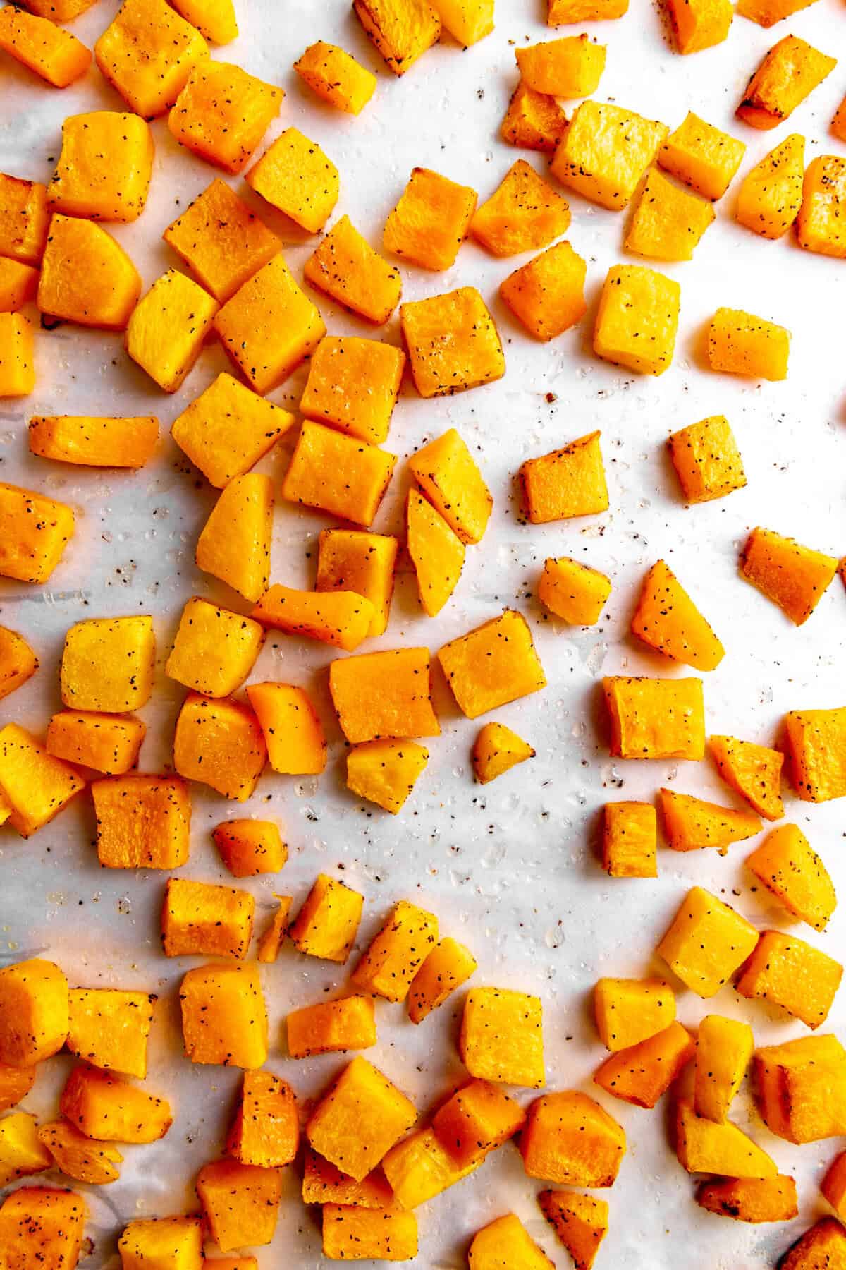 Roasted butternut squash on a baking sheet.