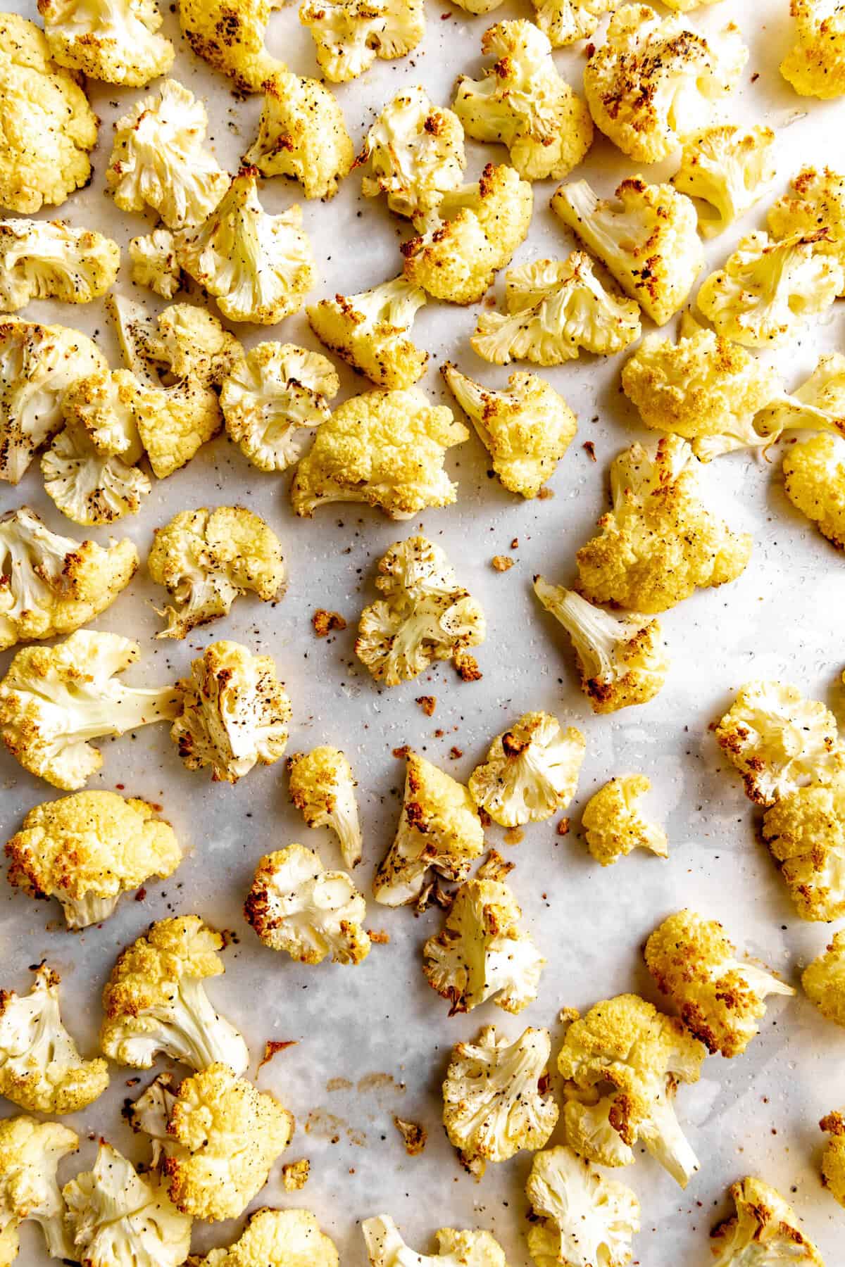 Roasted cauliflower on a baking sheet.