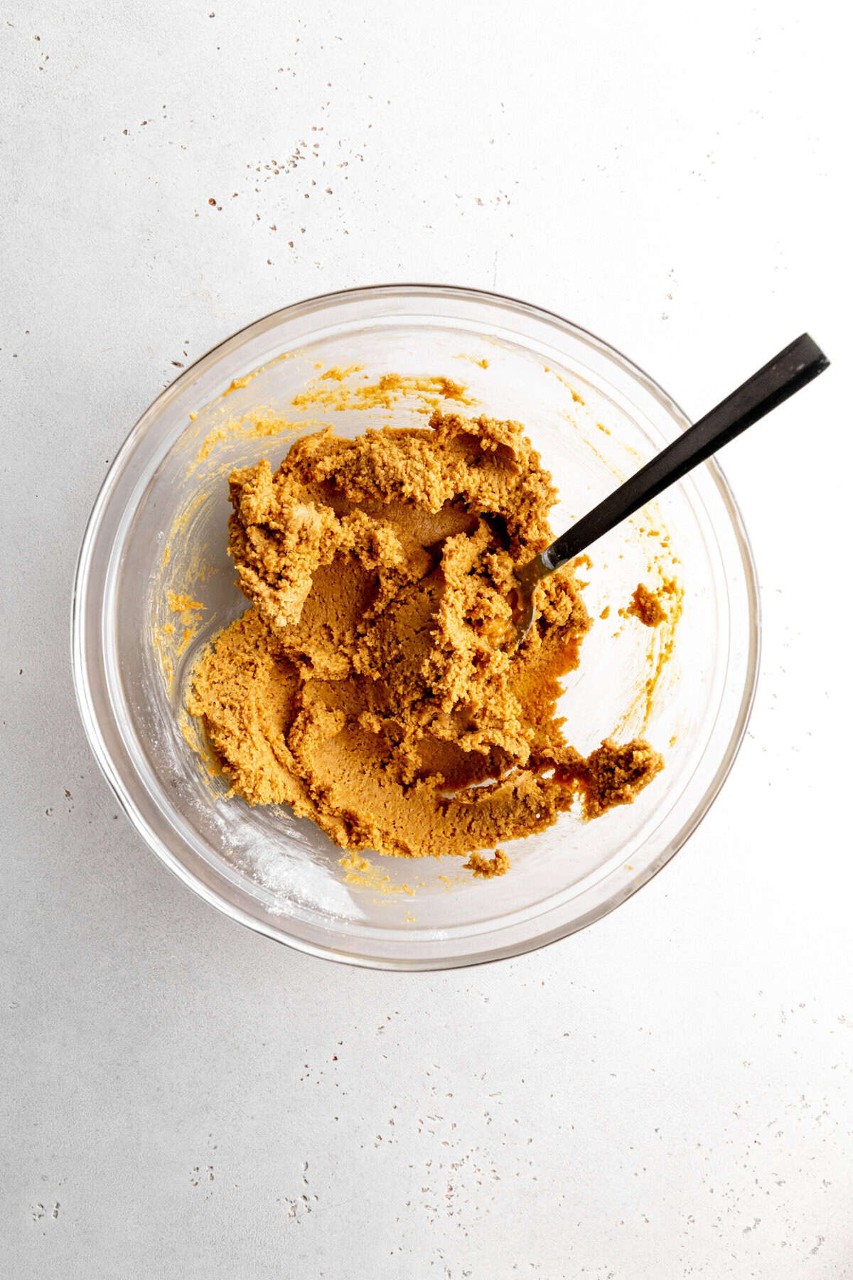 Peanut butter cup filling in a glass bowl with a spoon.
