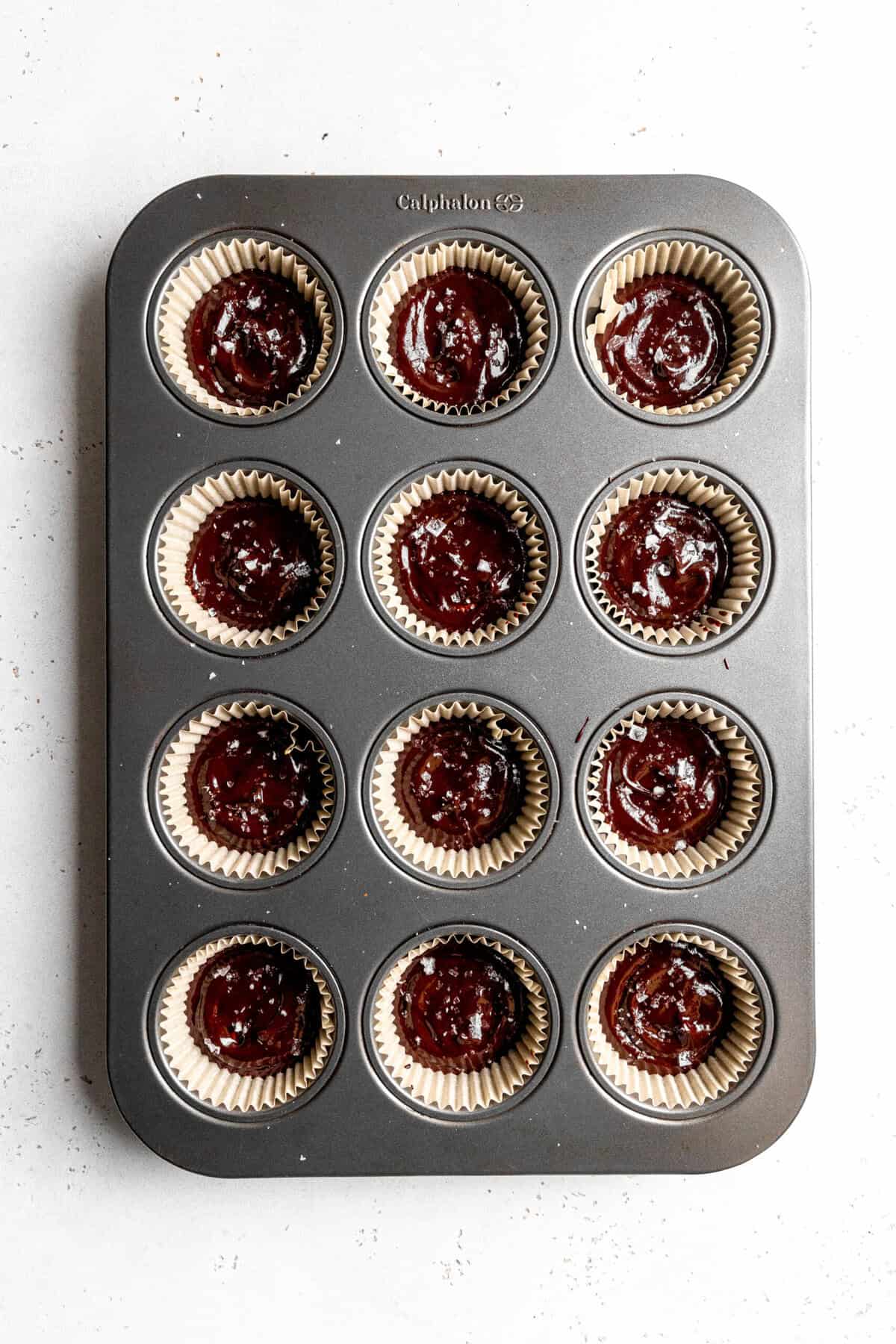 Chocolate peanut butter cups in a cupcake pan.