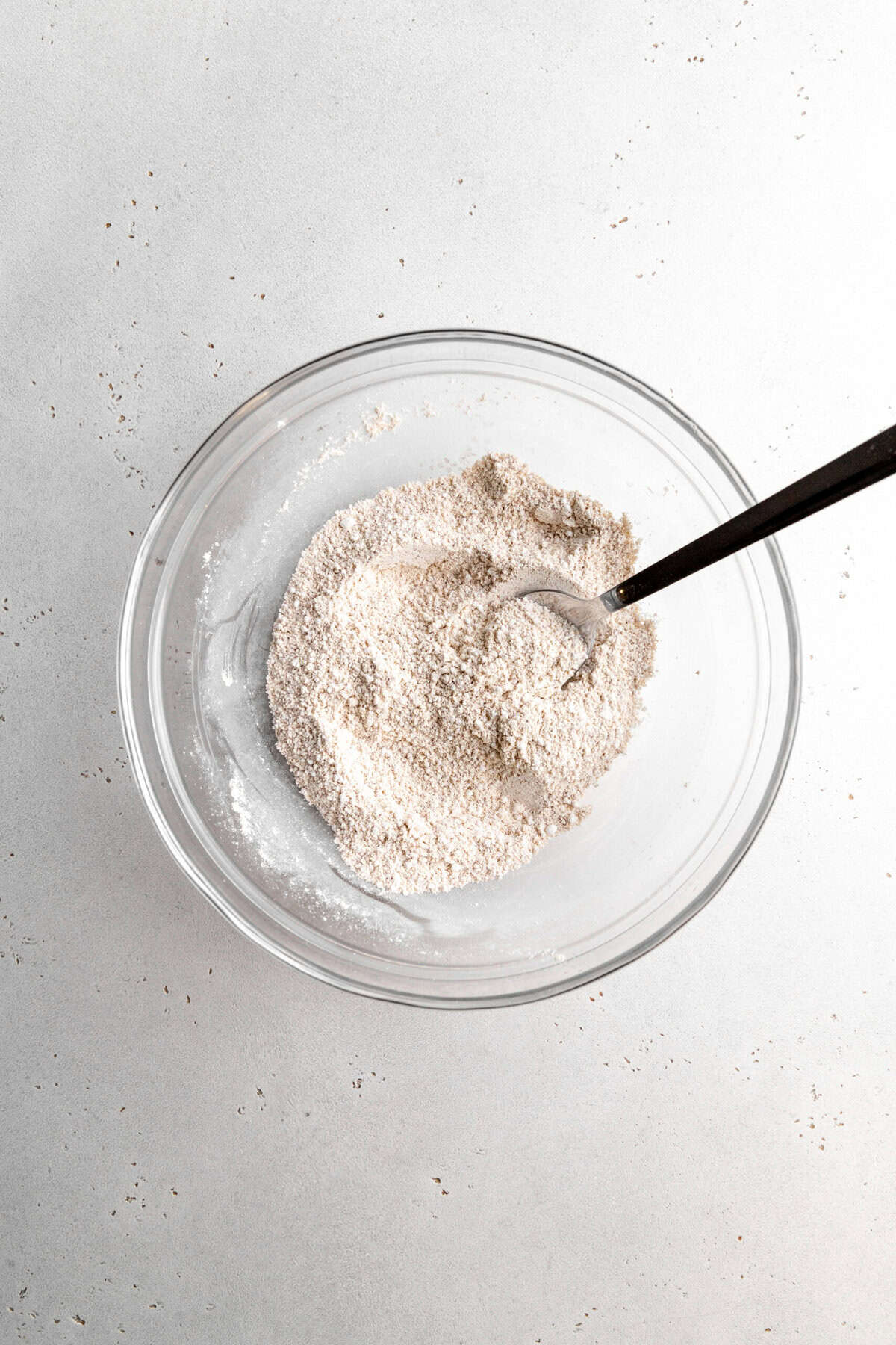 Graham cracker crumbs and powdered sugar in a glass bowl.