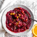 Spoon in a bowl of cranberry sauce.