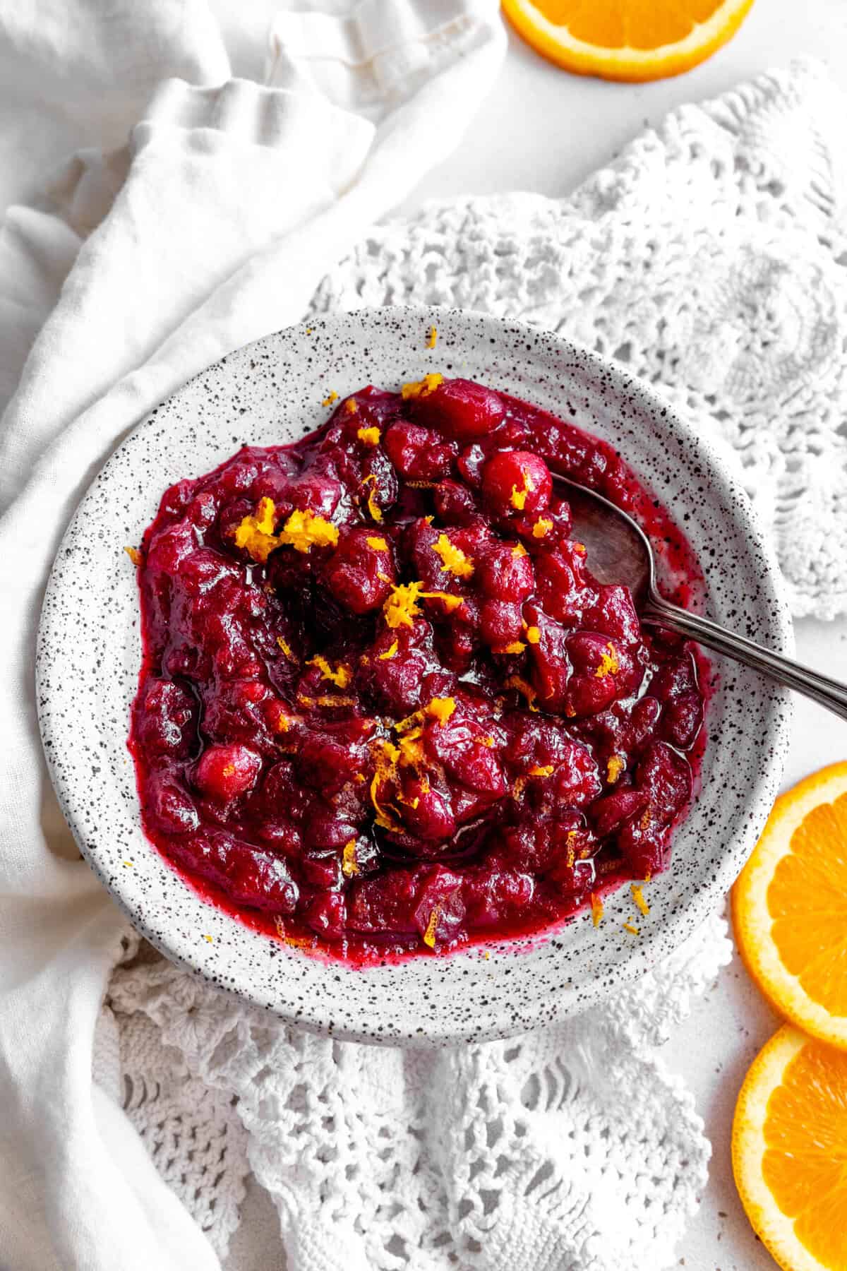 Spoon in a bowl of cranberry sauce.
