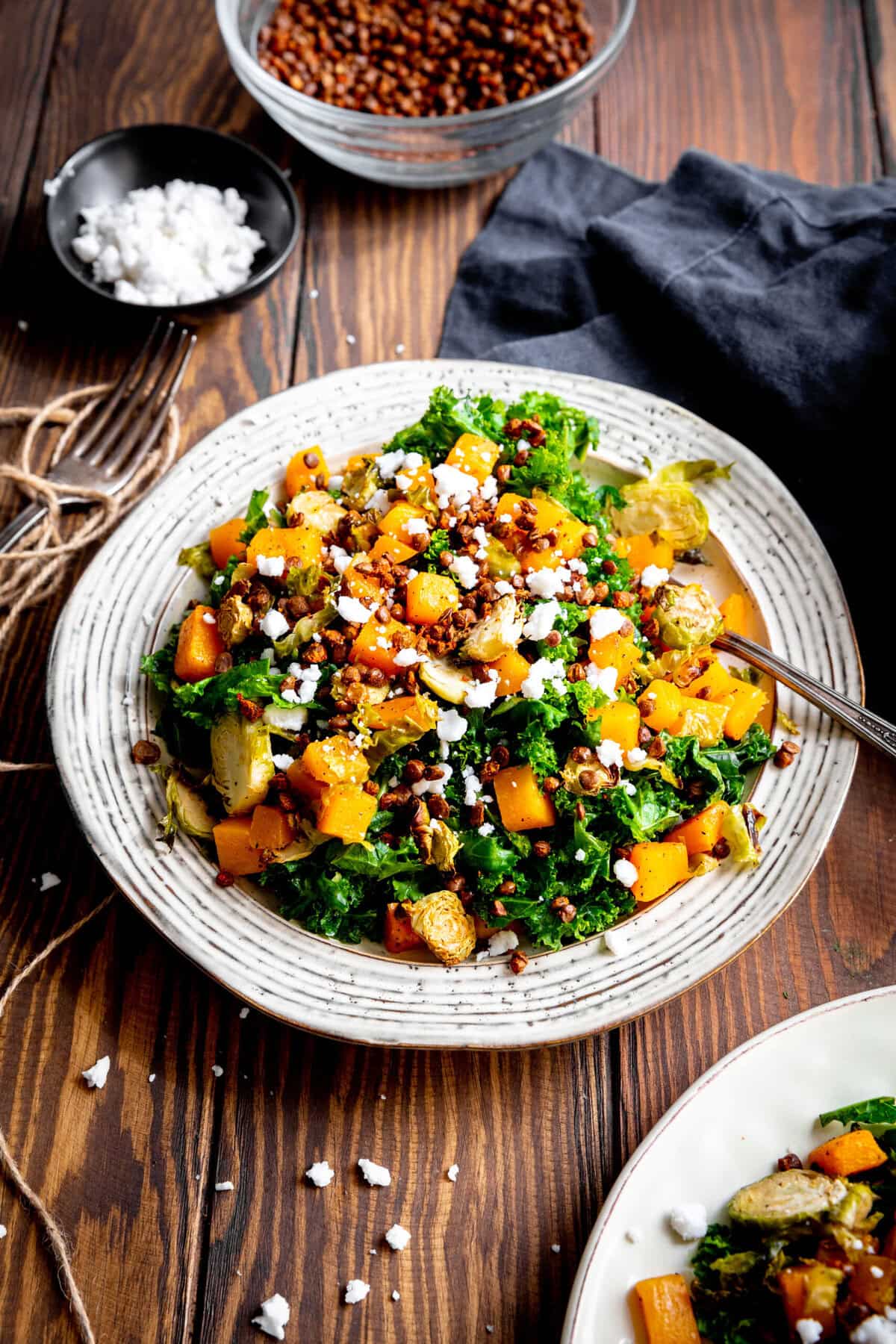 Fork digging into a kale butternut squash salad.
