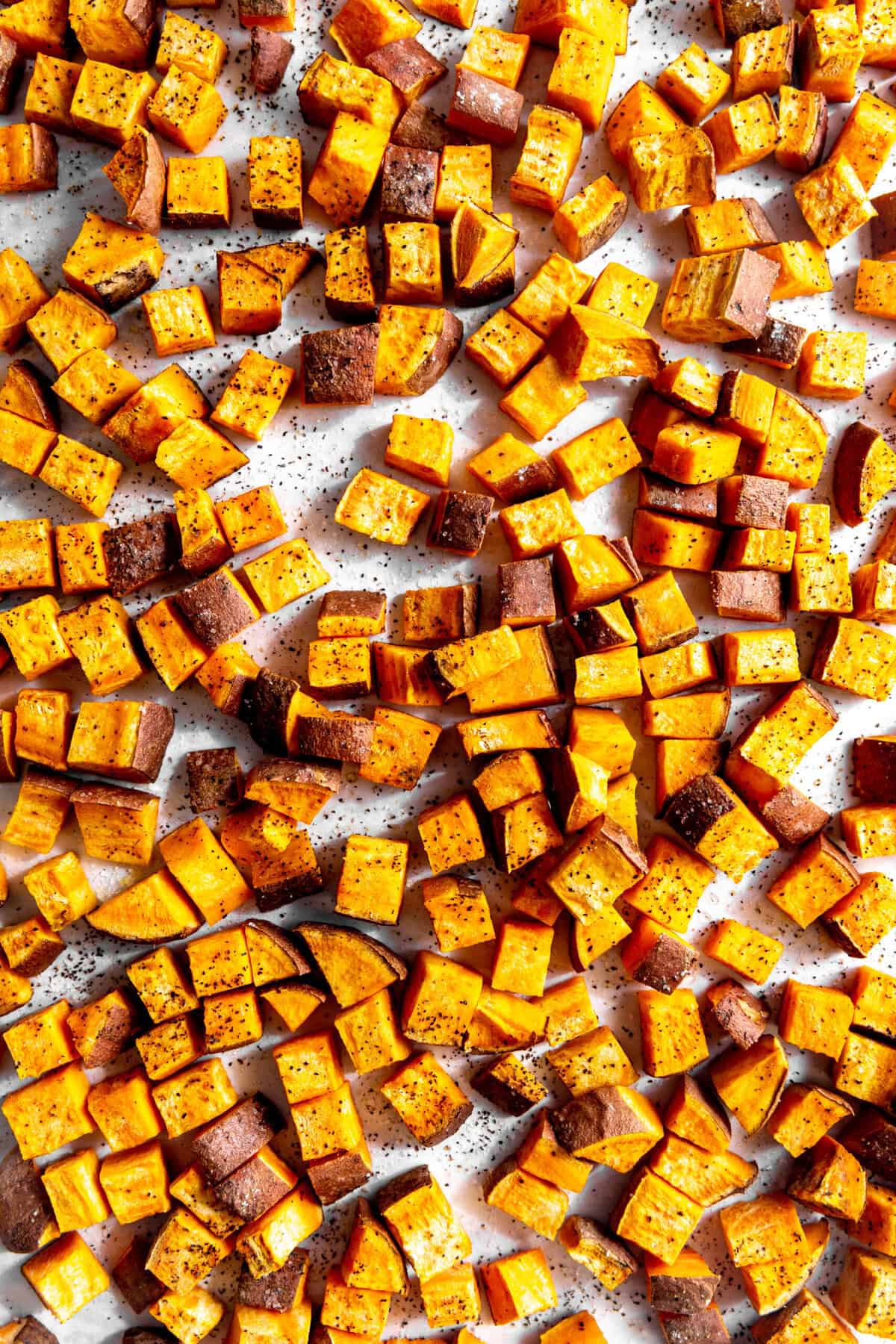 Roasted sweet potatoes on a bking sheet.