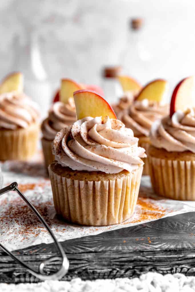 Apple cinnamon cupcake topped with a fresh apple slice.
