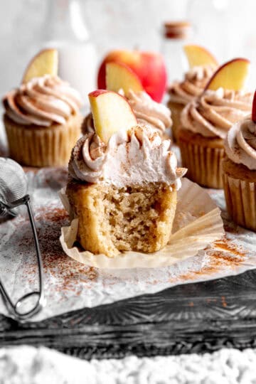Apple cinnamon cupcake with a bite taken out of it.