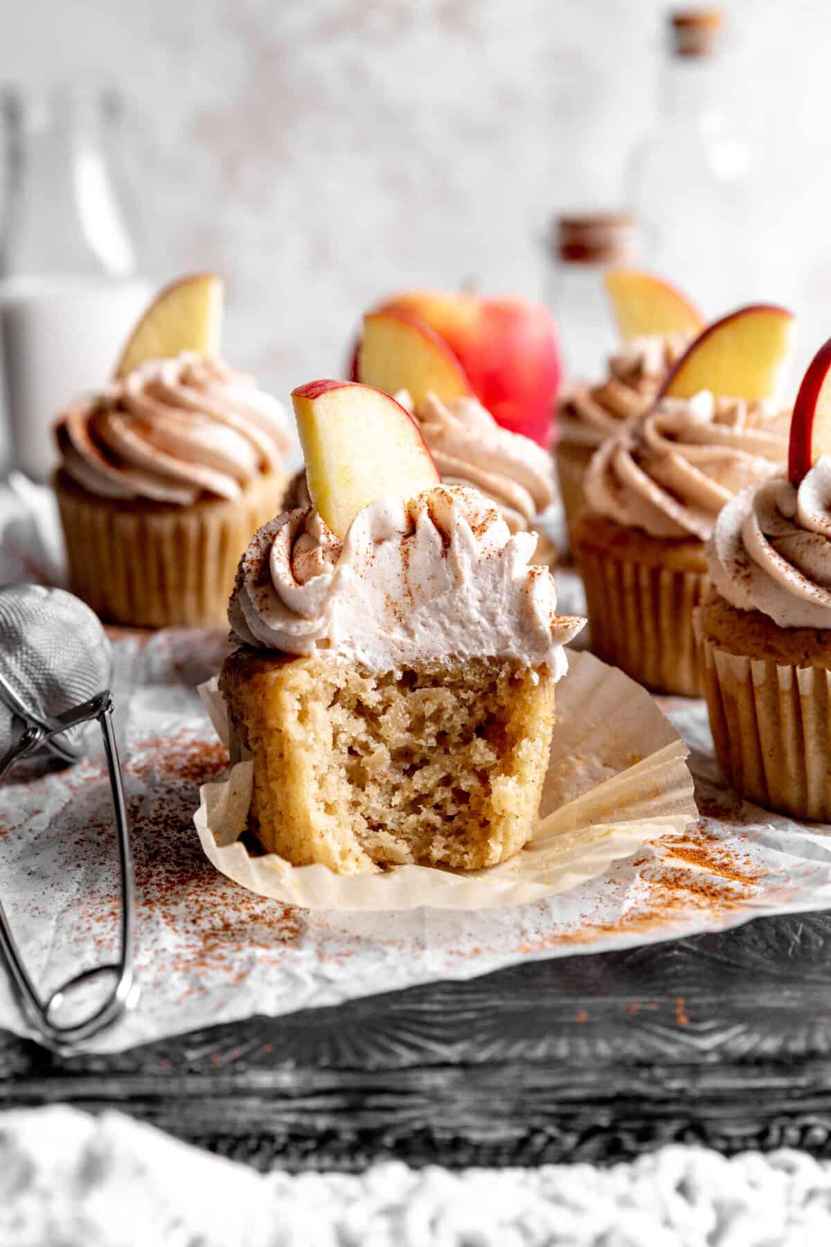 Apple cinnamon cupcake with a bite taken out of it.